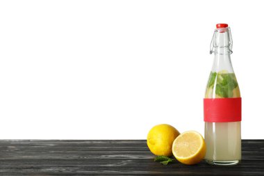 Beyaz arka plan karşı masada doğal limonata ile şişe