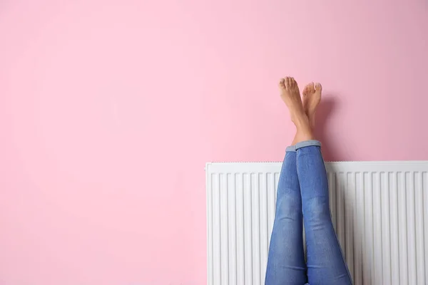 Woman Warming Legs Heating Radiator Color Wall Space Text — Stock Photo, Image