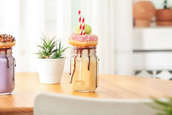 Mason Jar Med Läcker Milkshake Bordet Mot Suddig Bakgrund — Stockfoto