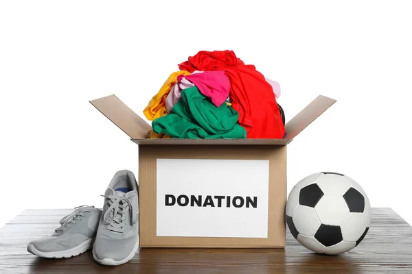 Donation Box Clothes Shoes Soccer Ball Table White Background — Stock Photo, Image