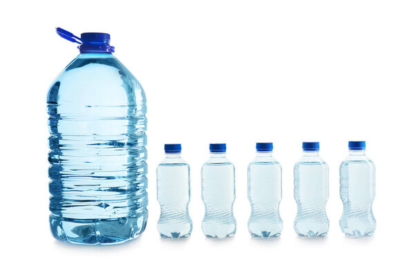 Large and small bottles of water on white background
