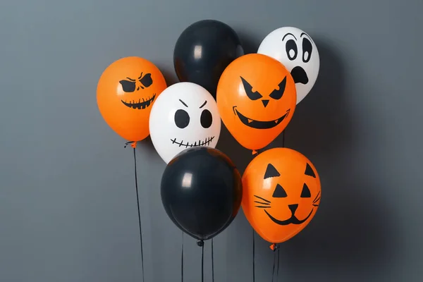 Color balloons for Halloween party on gray background