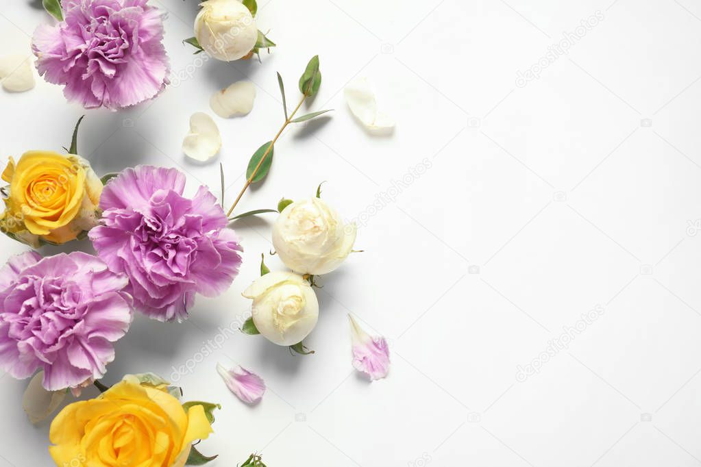 Flat lay composition with beautiful blooming flowers on white background