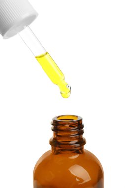 Yağ ile şişe üzerinde beyaz arka plan üzerinde pipet