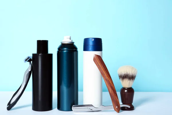 Shaving accessories for men on table against color background