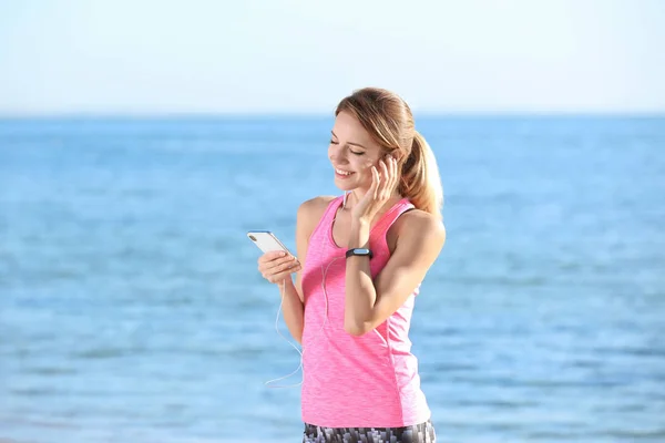 Młoda Kobieta Wybór Muzyki Ćwiczeń Fitness Plaży Rano — Zdjęcie stockowe