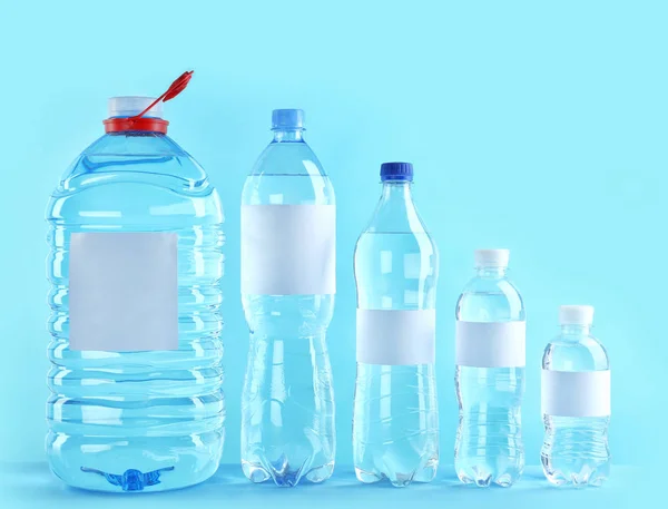 Different Bottles Pure Water Blank Tags Color Background — Stock Photo, Image