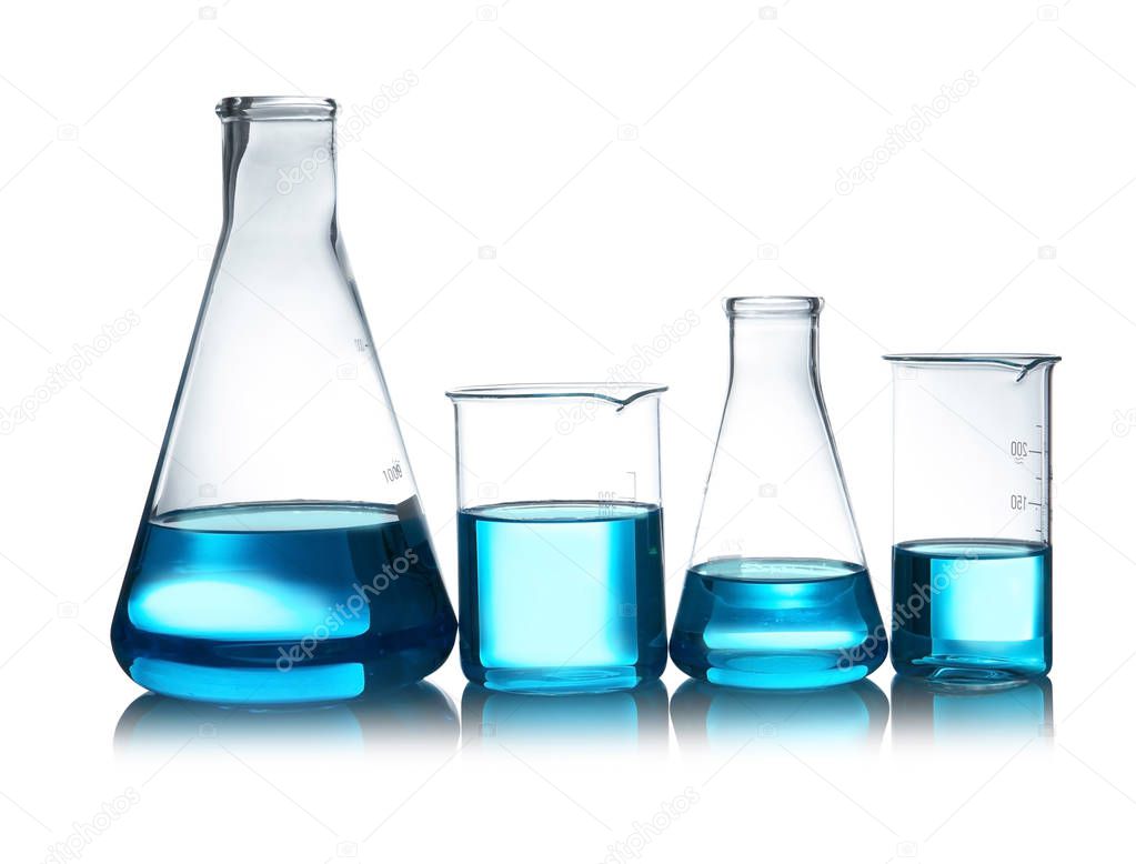 Laboratory glassware with liquid on table against white background. Chemical analysis