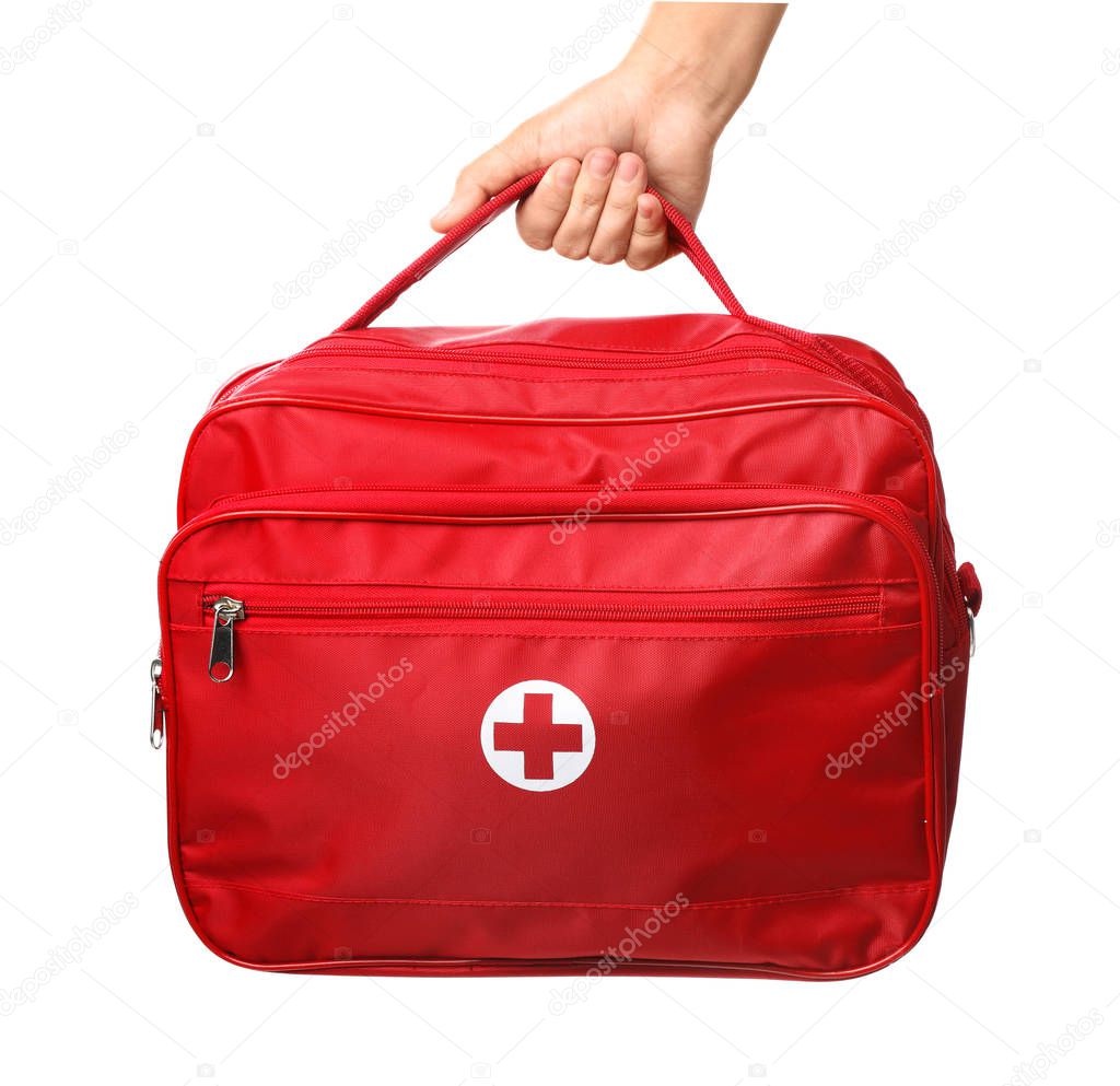 Woman holding first aid kit on white background