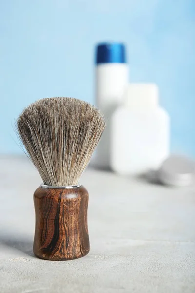 Shaving brush on table against blurred background