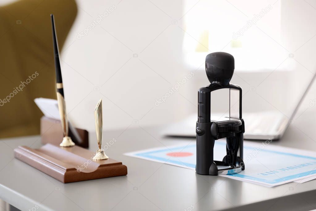 Automatic stamp and documents on desk in notary's office