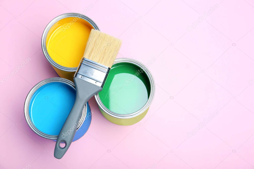 Flat lay composition with paint cans and brush on color background. Space for text