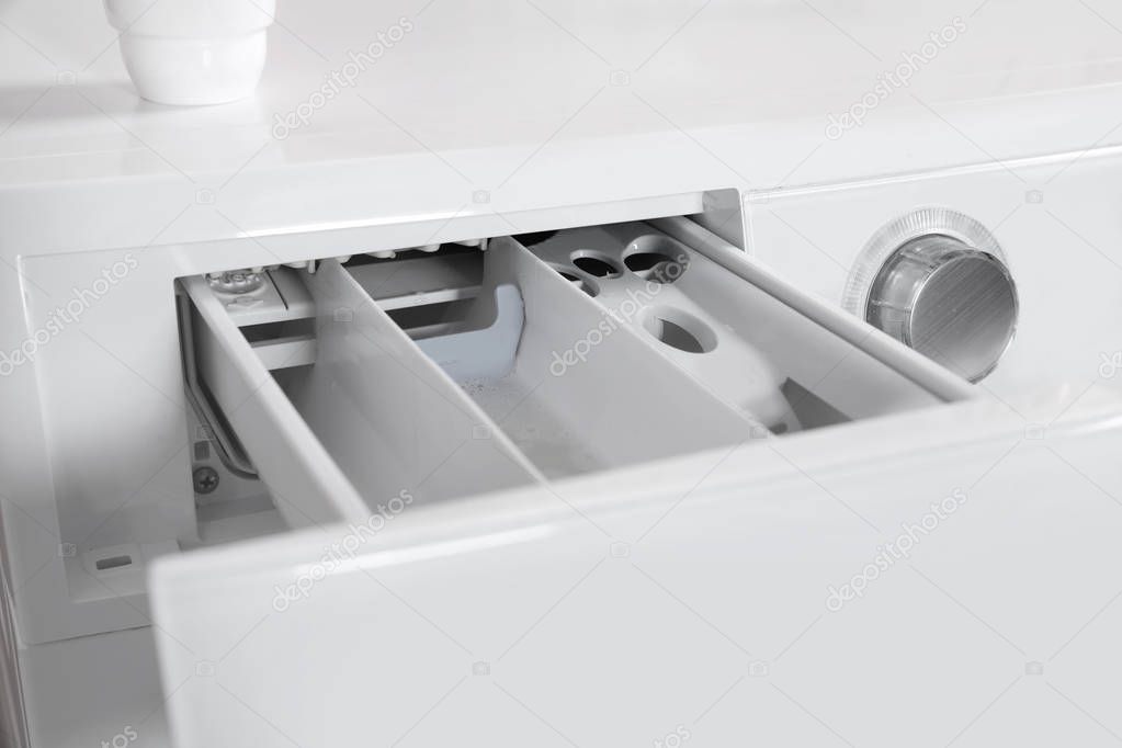 Washing machine with open detergent drawer, closeup. Laundry day