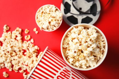 Lezzetli patlamış mısır ve film reel renk arka plan, üstten görünüm üzerinde. Sinema snack