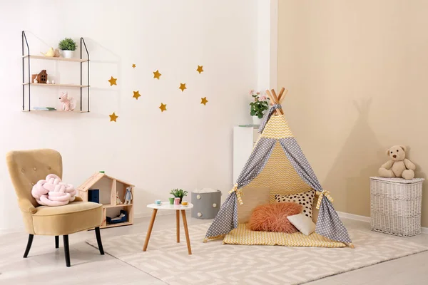 Cozy kids room interior with play tent and toys