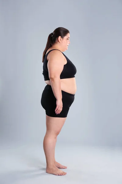 Overweight woman before weight loss on color background