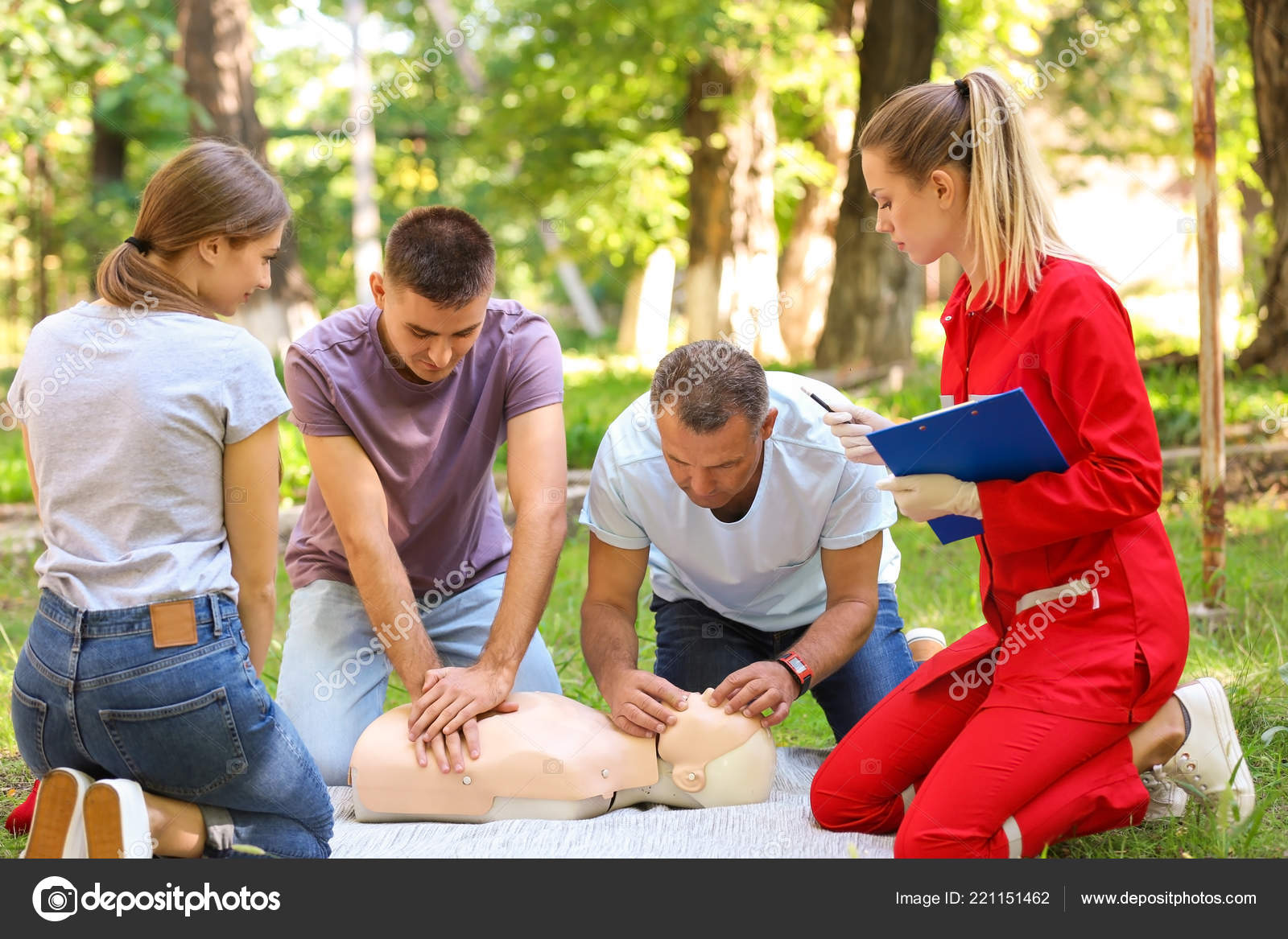 Group People Having First Aid Class Mannequin Outdoors Stock Photo by