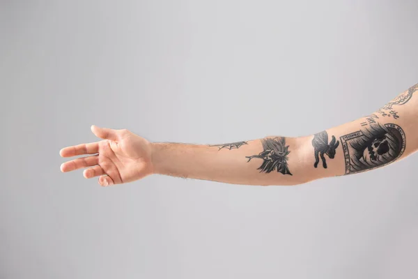 Young man with stylish tattoos on white background