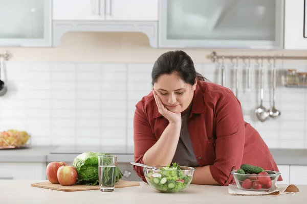 Woman choosing food from fridge at kitchen. Healthy diet