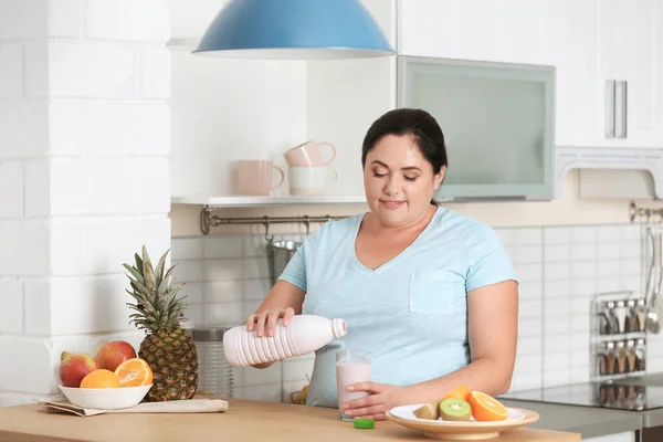 Woman choosing food from fridge at kitchen. Healthy diet