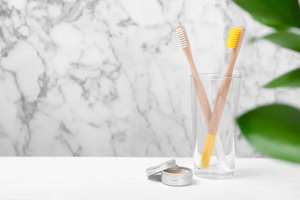 Glass Bamboo Toothbrushes Paste Table Blurred Background Space Text — Stock Photo, Image