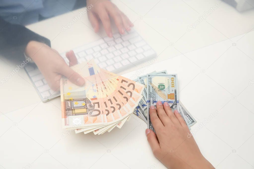Woman exchanging money at cash department window, closeup