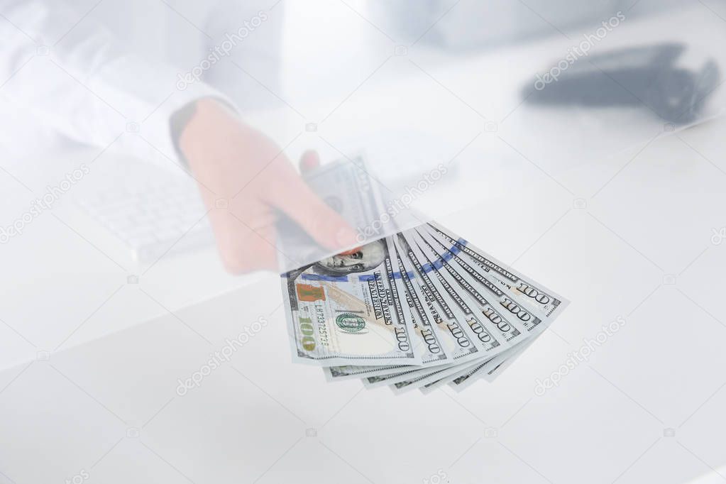 Teller with money at cash department window, closeup