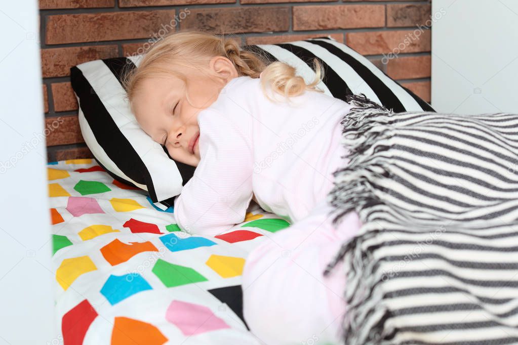 Cute little girl sleeping in bed at home