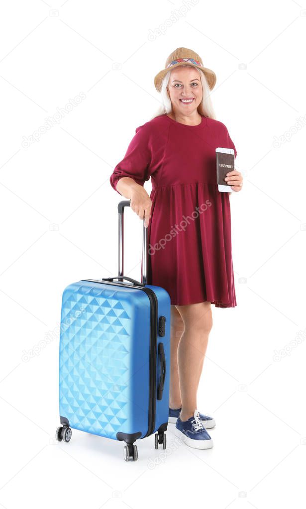 Senior couple with suitcases near color wall. Vacation travel