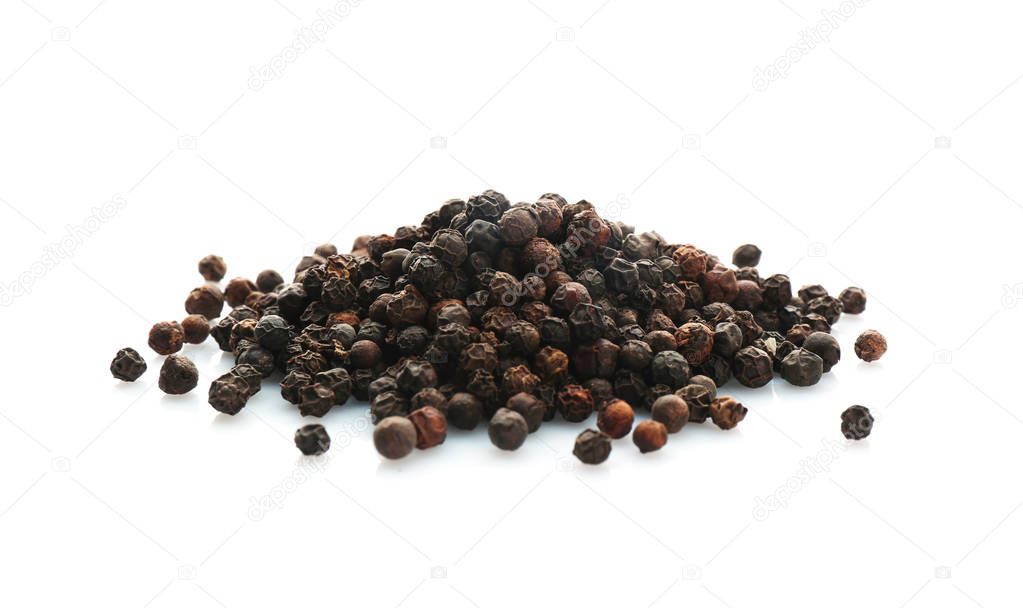 Black pepper grains on white background. Natural spice