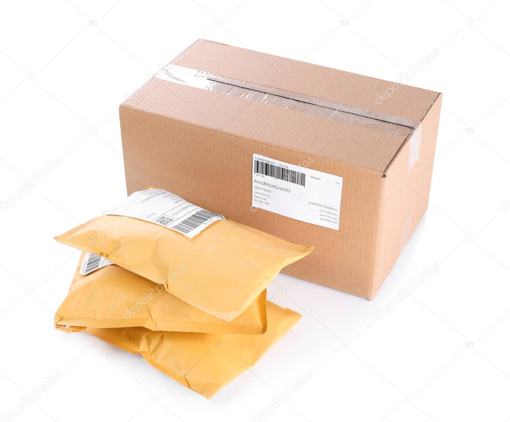 Padded envelopes and cardboard parcel on white background