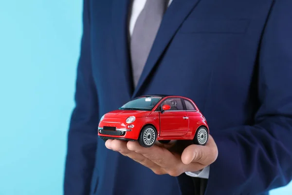 Insurance Agent Holding Toy Car Color Background Closeup — Stock Photo, Image