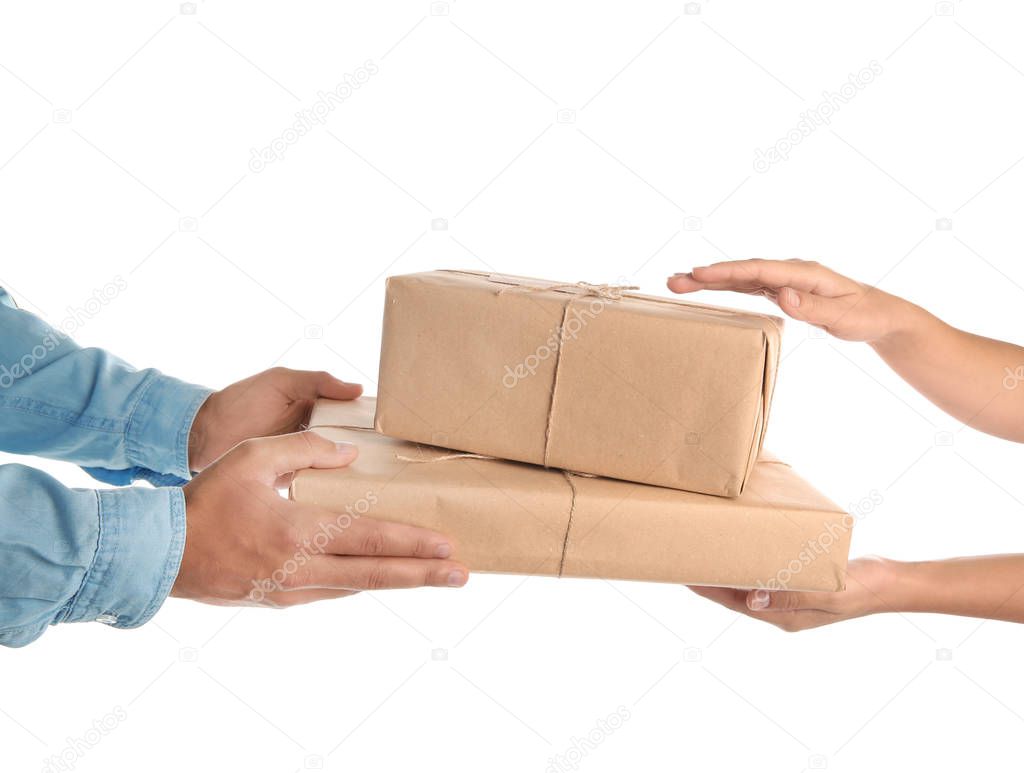 Woman receiving parcels from courier on white background, closeup