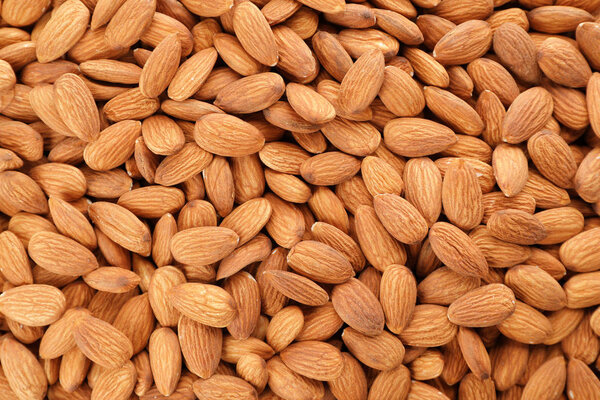 Organic almond nuts as background, top view. Healthy snack