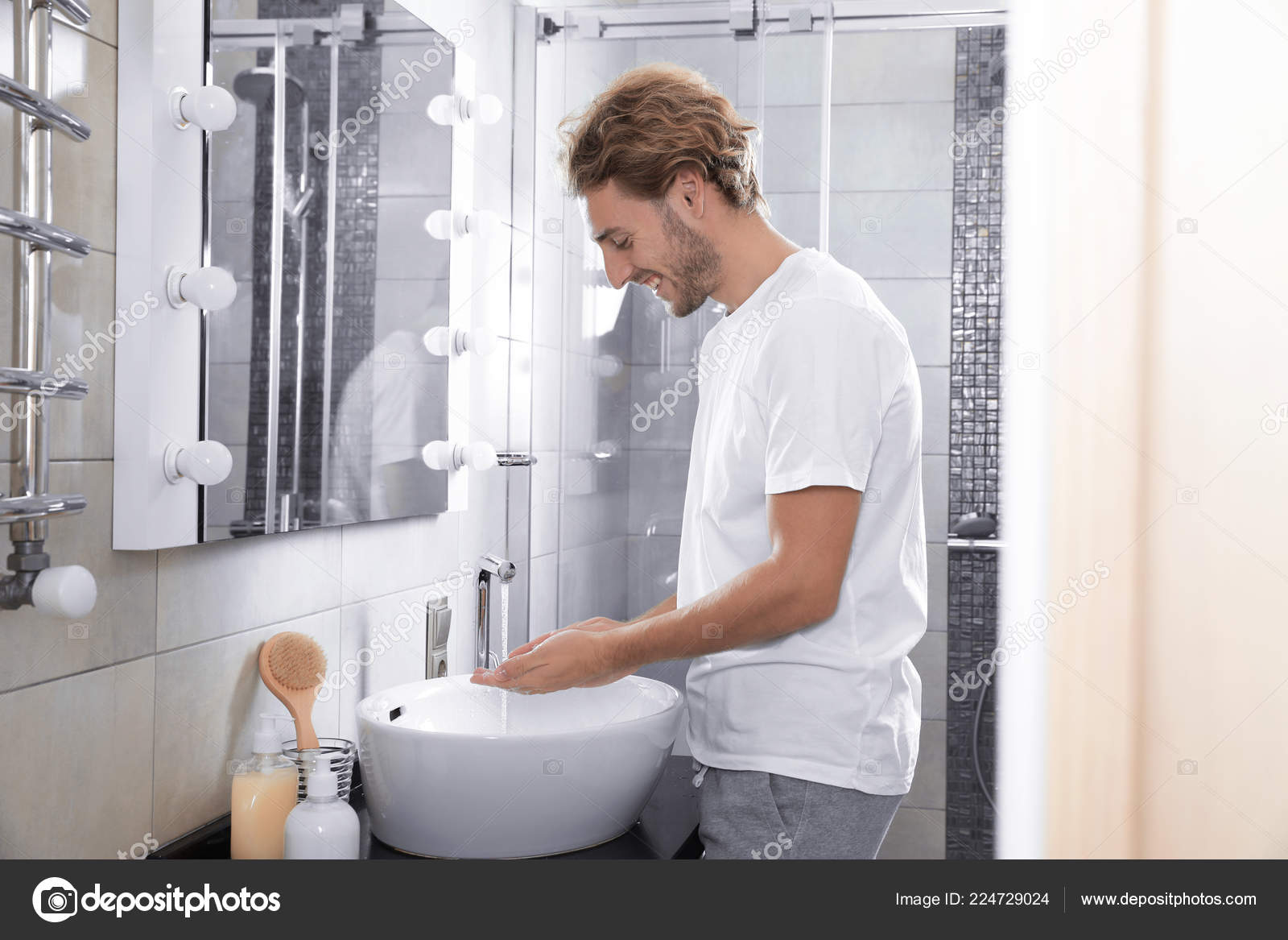 Young Man Washing Hands Bathroom Using Soap Stock Photo by ©NewAfrica