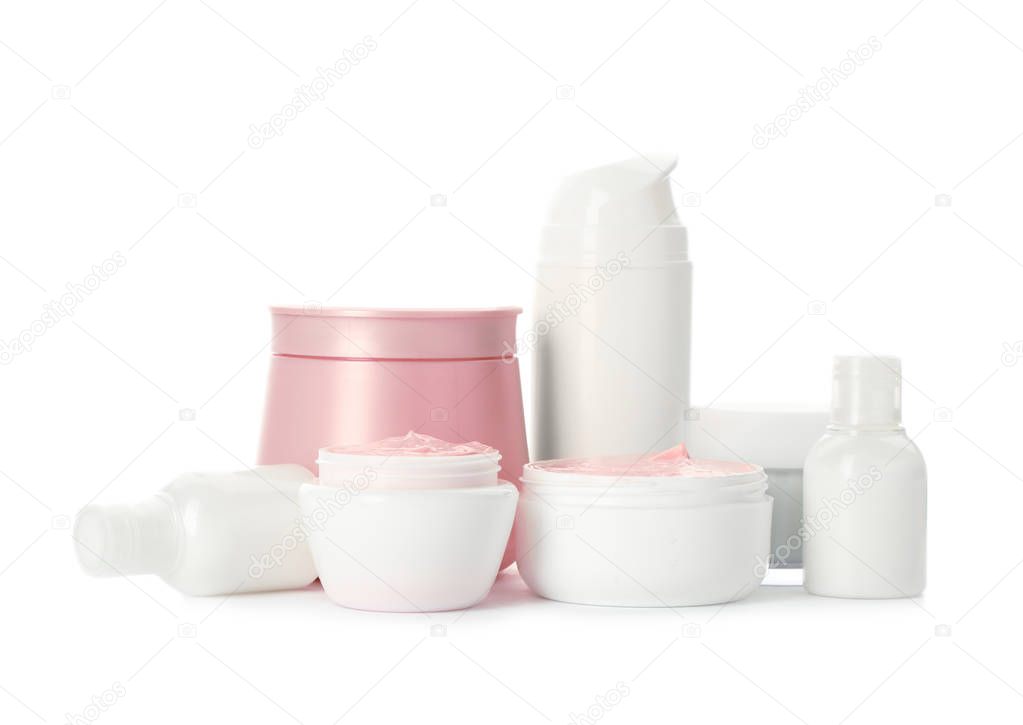 Different containers with hand cream and other cosmetic on white background