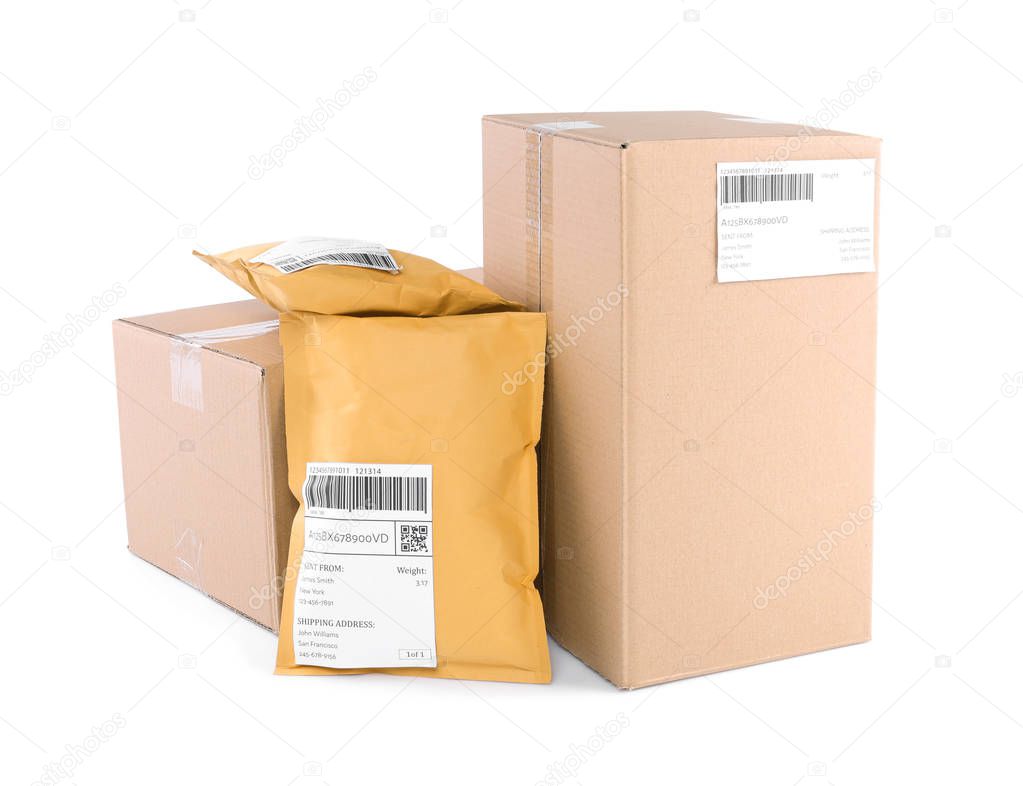 Padded envelopes and cardboard parcels on white background