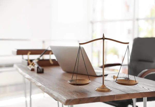 Scales of justice on desk in notary\'s office