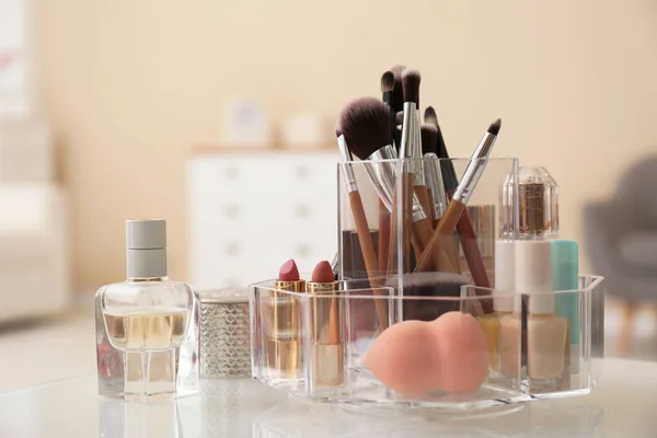 Organizer with cosmetic products for makeup on table indoors