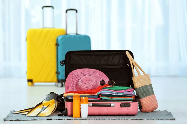 Modern Suitcase Full Clothes Accessories Floor Indoors — Stock Photo, Image