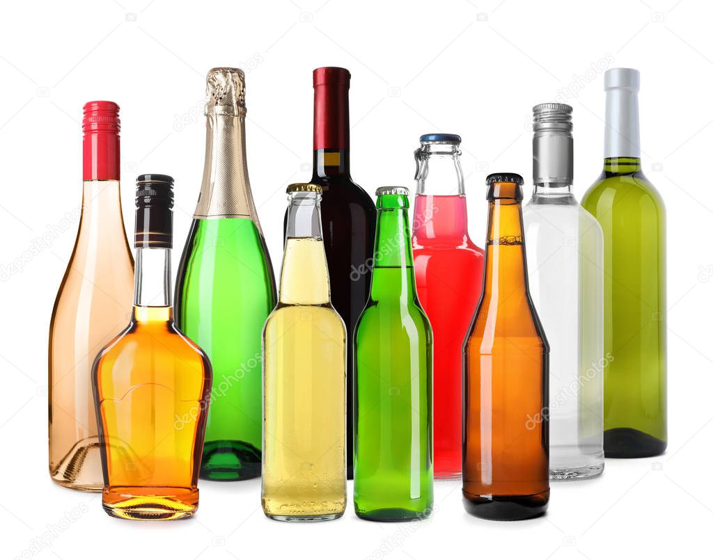 Set of bottles with different drinks on white background