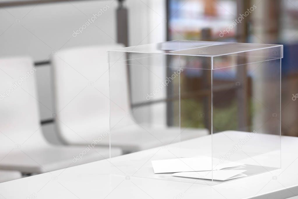 Ballot box on table at polling station. Space for text