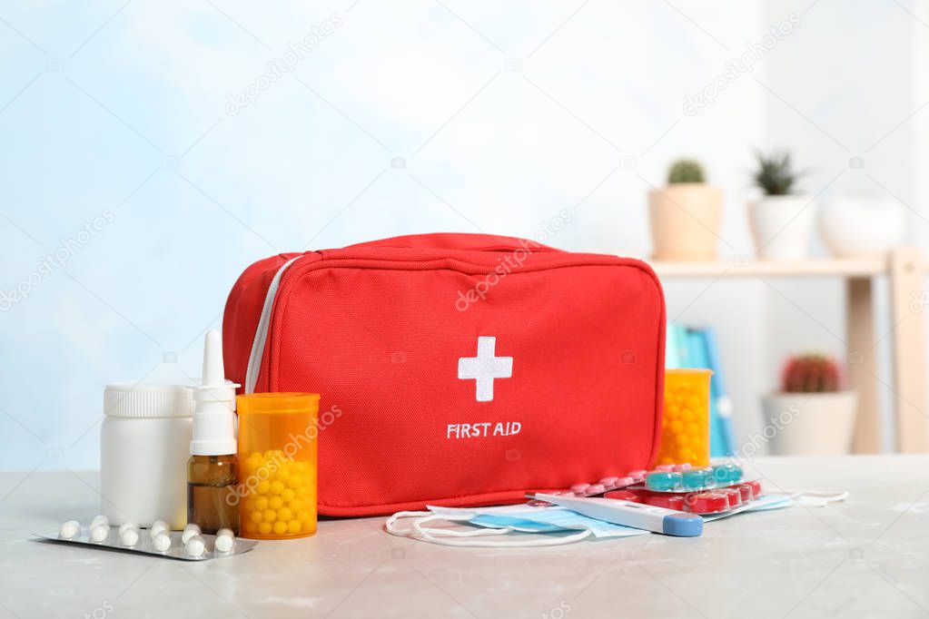 First aid kit with pills on table indoors