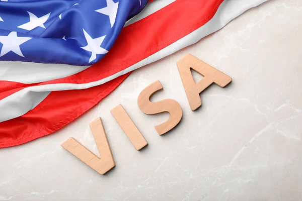 stock image Flat lay composition with word VISA and flag of USA on gray background