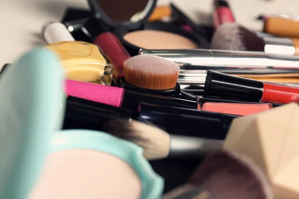 Set of different makeup products and tools as background, closeup
