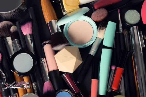 Set of different makeup products and tools as background, top view