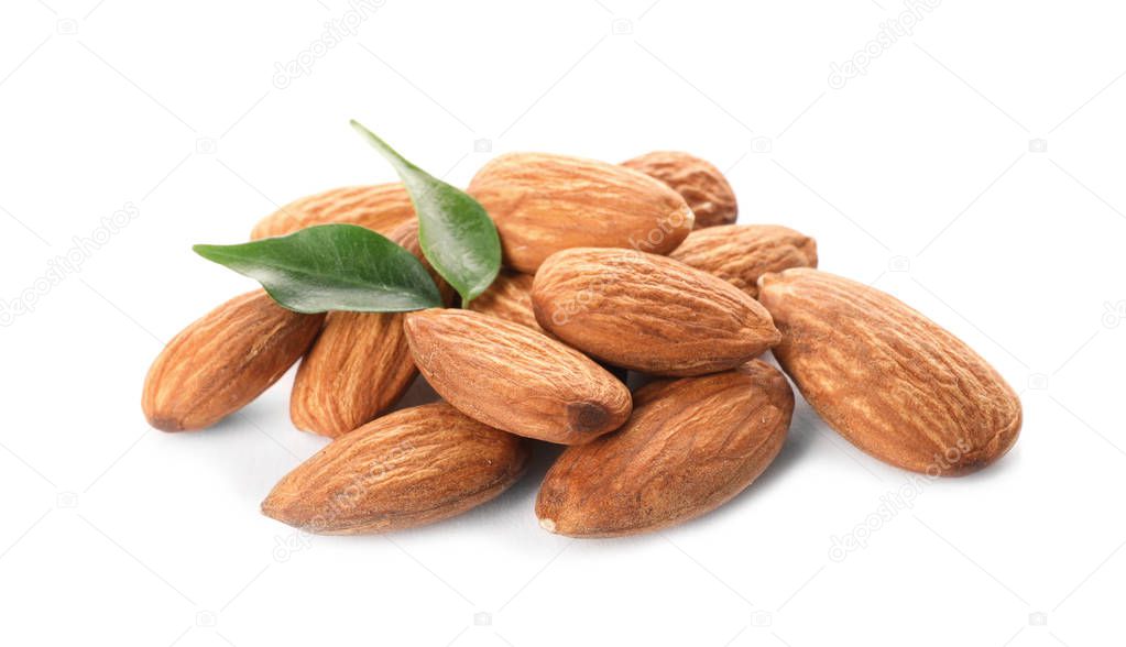 Organic almond nuts and leaves on white background. Healthy snack