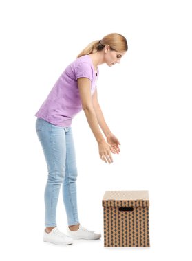 Full length portrait of woman lifting carton box on white background. Posture concept clipart