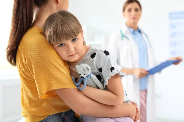 Little girl with parent visiting children\'s doctor in hospital