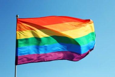 Gökkuşağı Lgbt bayrağı mavi gökyüzü arka planda çırpınan. Eşcinsel hakları hareketi